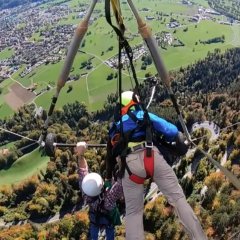 Unattached Hang-Glider Desperately Clings to Pilot