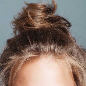 The Real Reason You Should Sleep With Your Hair in a Bun